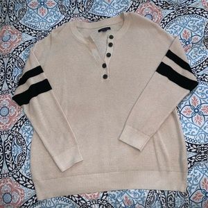 Cream sweater with black shoulder stripes